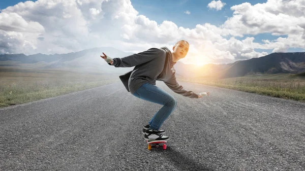 Teenager girl ride her skateboard. Mixed media — Stock Photo, Image