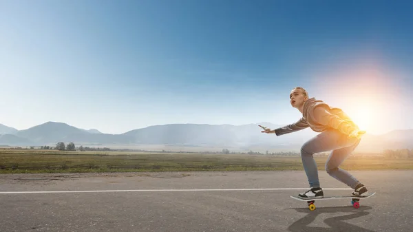 Teenager girl ride her skateboard. Mixed media — Stock Photo, Image