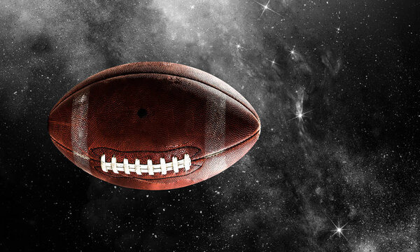 Rugby ball floating in starry dark space . Mixed media
