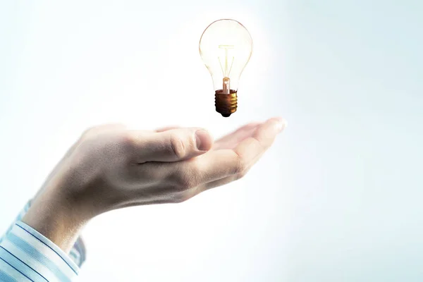 Glass bulb in hands — Stock Photo, Image