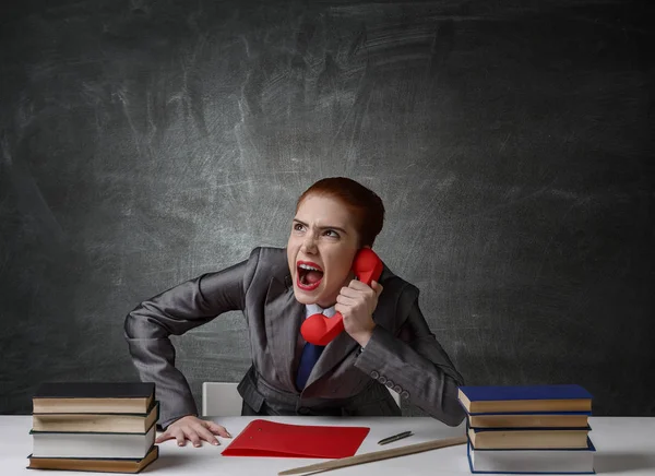 Aggressive red hair teacher . Mixed media — Stock Photo, Image