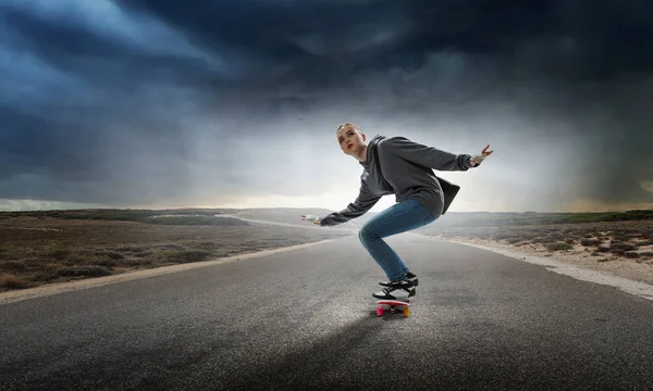 Teenager girl ride her skateboard. Mixed media — Stock Photo, Image