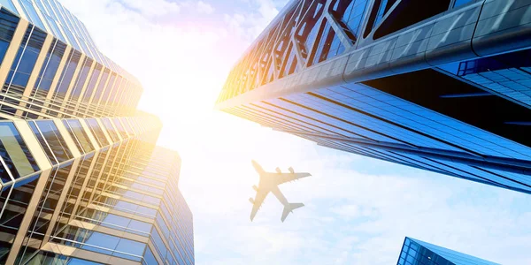 Airplane above business city — Stock Photo, Image