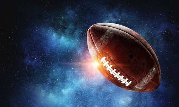 Rugby ball floating in starry dark space . Mixed media