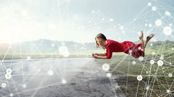 Woman Red Dress Levitates Air Smartphone Hands Mixed Media — Stock Photo, Image