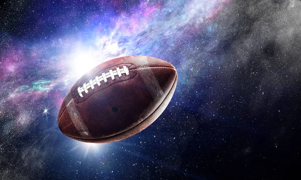 オープン スペースに浮かぶアメリカン フットボールのボール — ストック写真