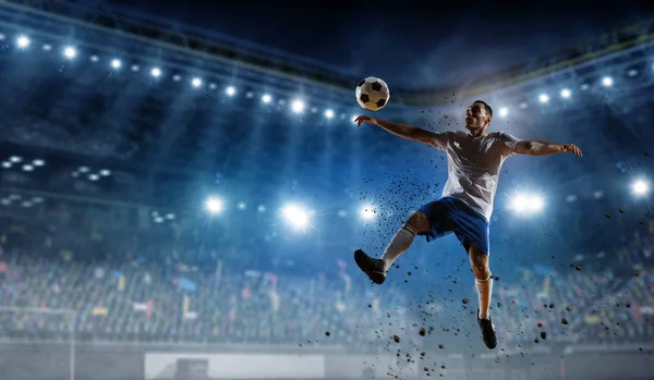 Soccer player at stadium. Mixed media — Stock Photo, Image