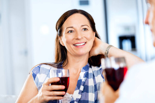 Woman with holding a glass of wine indoors