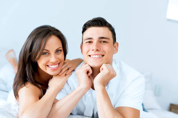 Young couple in the bed Royalty Free Stock Photos