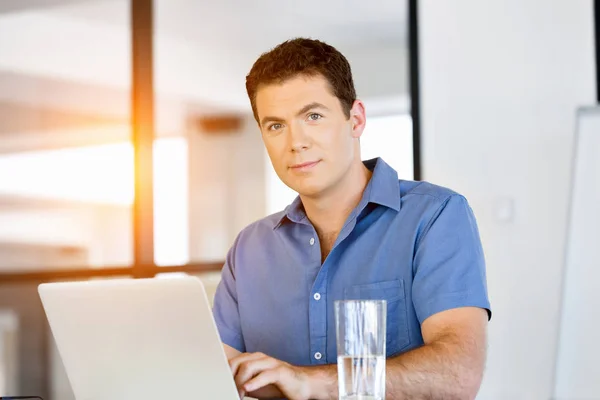 Young man in casual in office — Stock Photo, Image