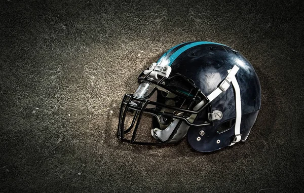 American football helmet on grass — Stock Photo, Image