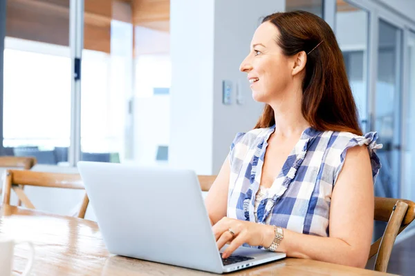 Rijpe mooie vrouw die op haar laptop werkt — Stockfoto