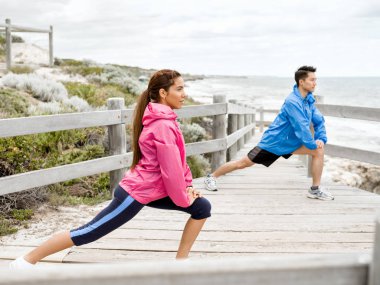 Egzersizleri yapıyor deniz kenarında genç Çift