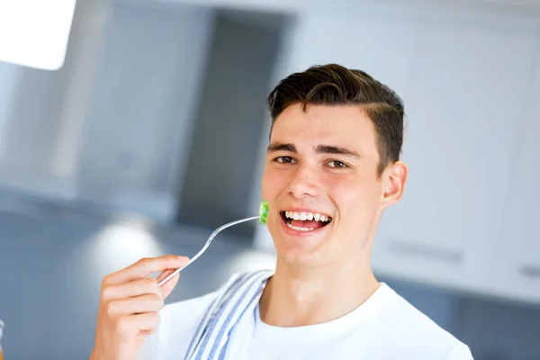 Young man with a fork — Stock Photo, Image