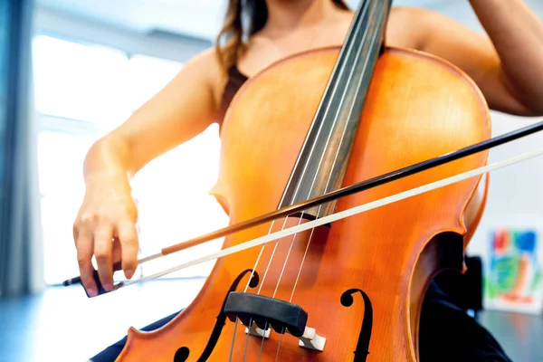 Närbild av cello med rosett i händerna — Stockfoto