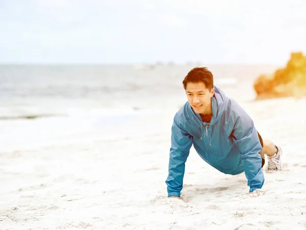 Young man doing exercise at the beach — Stock Photo, Image