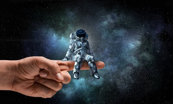 Spaceman on finger. Mixed media — Stock Photo, Image