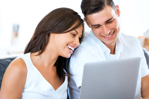 Feliz pareja moderna trabajando en el ordenador portátil en casa — Foto de Stock
