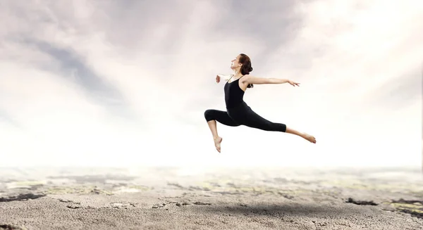 Gymnast girl in jump Mixed media — Stock Photo, Image