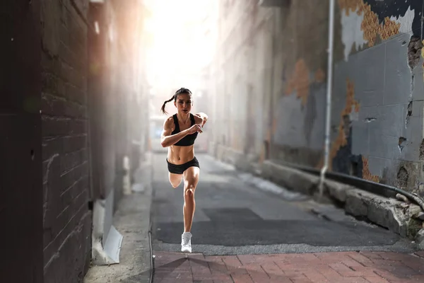 Sportswoman running race. Mixed media — Stock Photo, Image