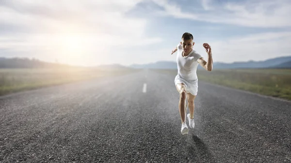 Athlete man running race. Mixed media — Stock Photo, Image