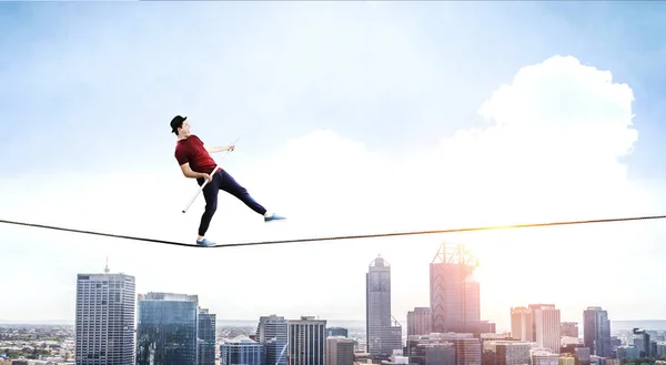 Brave ropewalker on cable. Mixed media — Stock Photo, Image