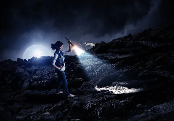 Young woman holding a flashlight — Stock Photo, Image