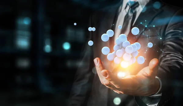 Businessman hand holding a bunch of spheres levitating above. Mixed media — Stock Photo, Image