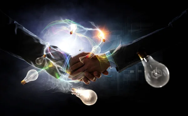 Business handshake by a man and a woman. Mixed media — Stock Photo, Image