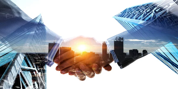 Business handshake by a man and a woman. Mixed media — Stock Photo, Image