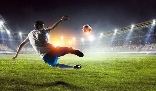 Soccer player on stadium in action. Mixed media — Stock Photo, Image