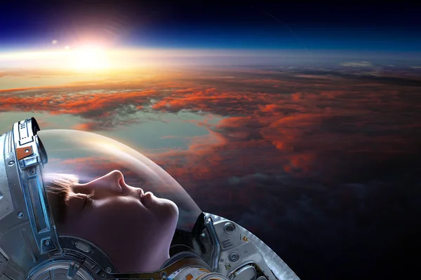 Female astronaut in space on planet orbit. — Stock Photo, Image