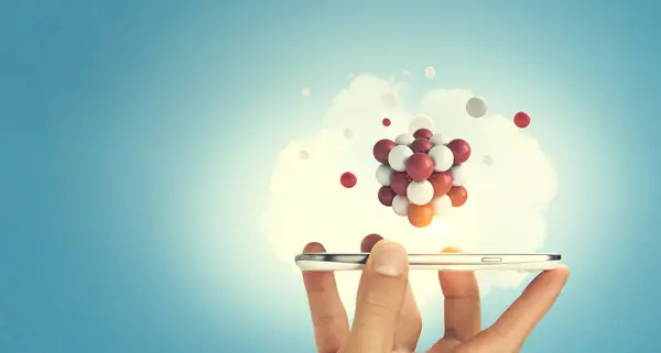 Zakenman hand met een smartphone met een heleboel bollen zwevende boven. Mixed media — Stockfoto