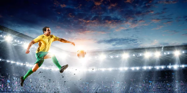 Soccer player on stadium in action. Mixed media — Stock Photo, Image