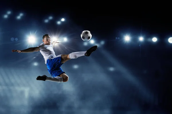 Soccer player on stadium in action. Mixed media — Stock Photo, Image