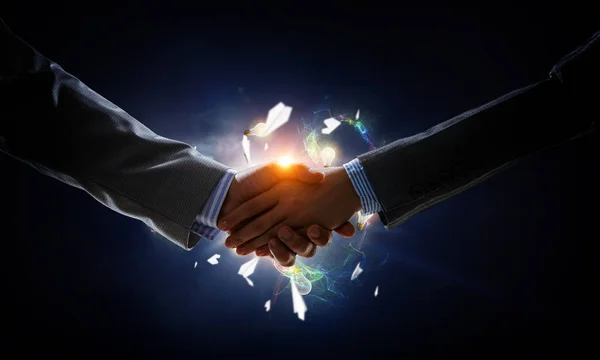 Business handshake by a man and a woman. Mixed media. — Stock Photo, Image