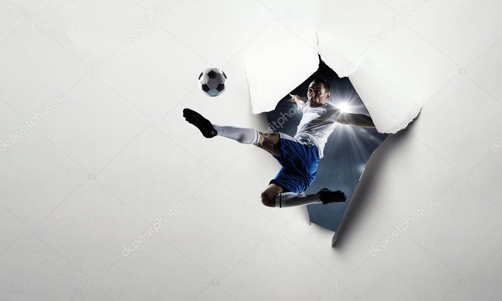 Paper breakthrough hole effect and soccer player. Mixed media