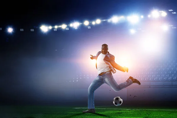 黑人男子踢他最好的足球比赛.混合媒体 — 图库照片