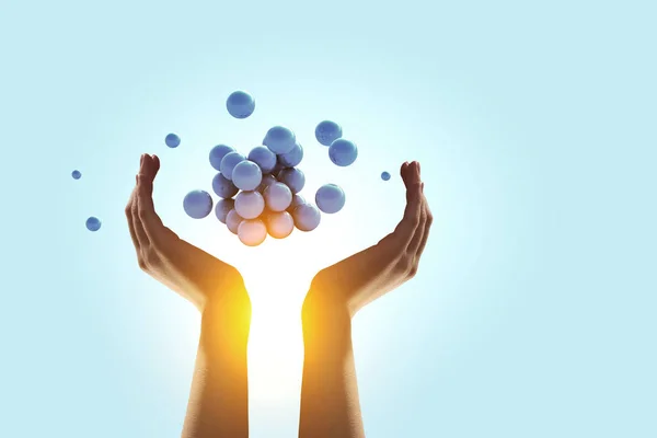 Woman hands and a bunch of spheres levitating above. Mixed media — Stock Photo, Image