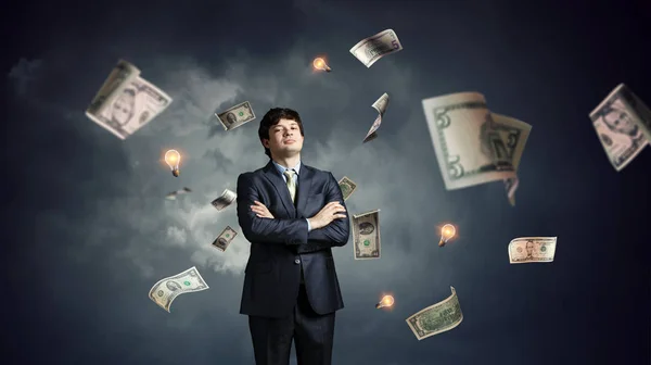 Young businessman standing with his hands crossed on his chest. Mixed media — Stock Photo, Image