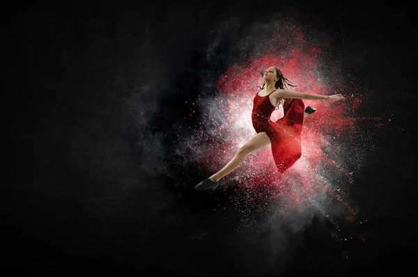Young and beautiful female dancer in a red dress. Mixed media — Stock Photo, Image
