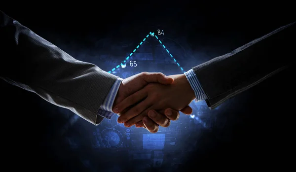 Business handshake by a man and a woman. Mixed media — Stock Photo, Image