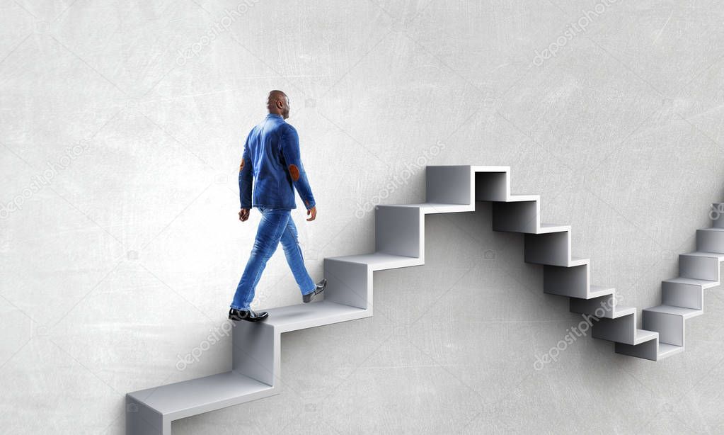 Black businessman climbing stone stairs illustrating career development and success concept. Mixed media