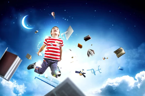 Cute happy little boy jumping. Mixed media — Stock Photo, Image