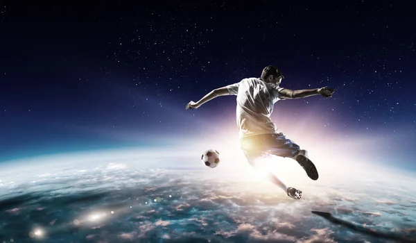 Soccer player in outer space in action. Mixed media — Stock Photo, Image