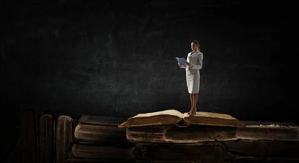 Young woman reading a book. Mixed media — Stock Photo, Image