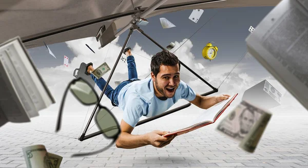Young man flying on hang glider. Mixed media — Stock Photo, Image
