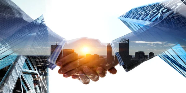 Business handshake by a man and a woman. Mixed media — Stock Photo, Image