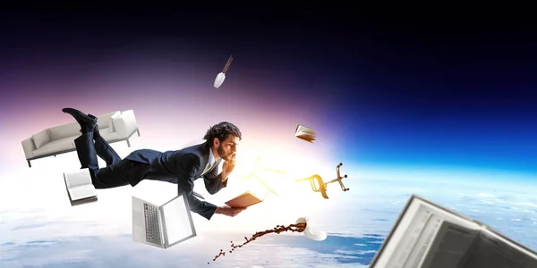 Man flies and works on laptop. Mixed media — Stock Photo, Image