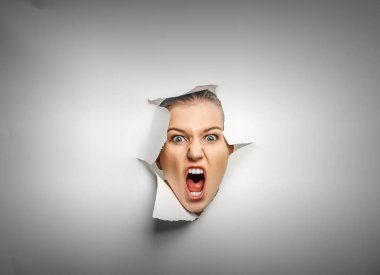 Yırtık bir kağıt deliğinden dışarı bakan kadın